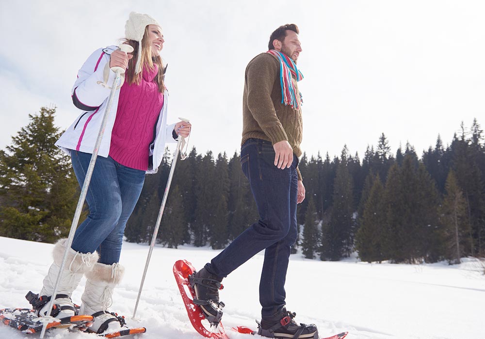 Young couple snowshoeing