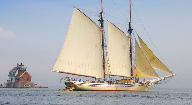 A schooner cruises past Rockland Breakwater Light House