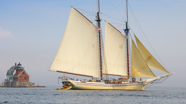 A schooner cruises past Rockland Breakwater Light House