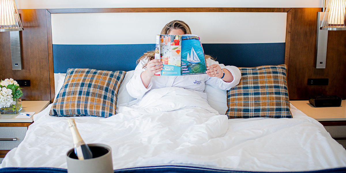 Woman relaxing in a hotel room in MidCoast Maine