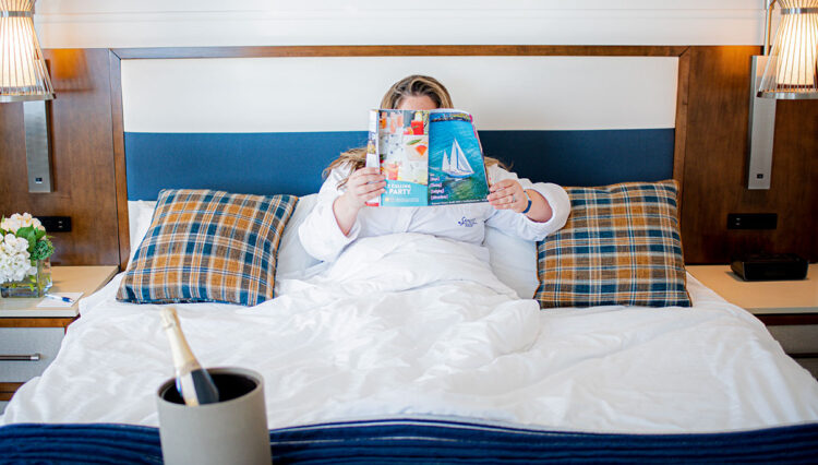 Woman relaxing in a hotel room in MidCoast Maine