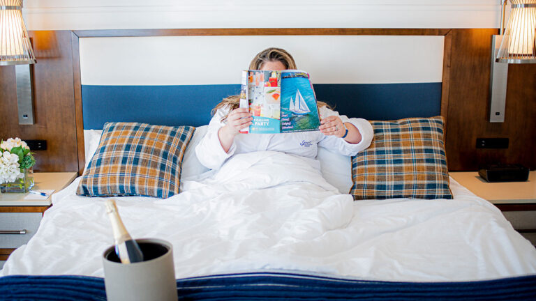 Woman relaxing in a hotel room in MidCoast Maine